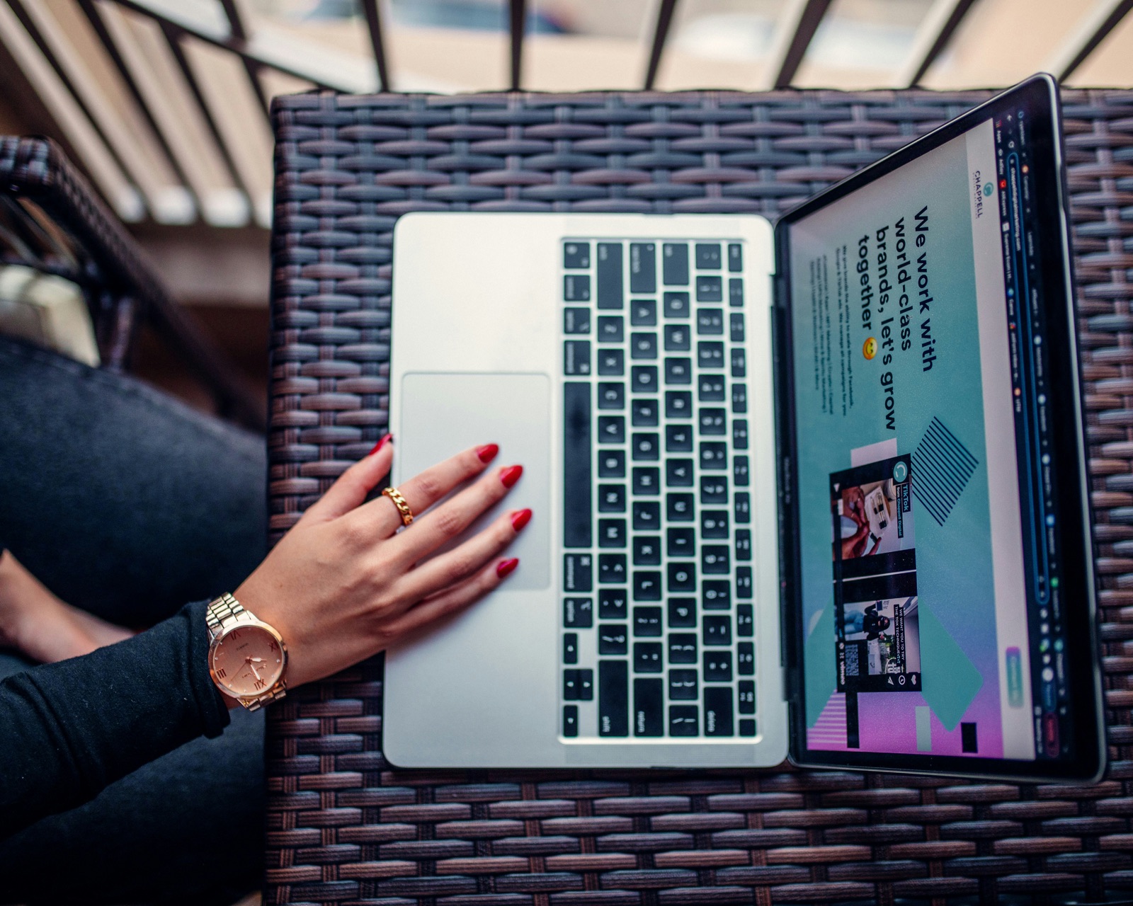 Hand on laptop showing client portfolio