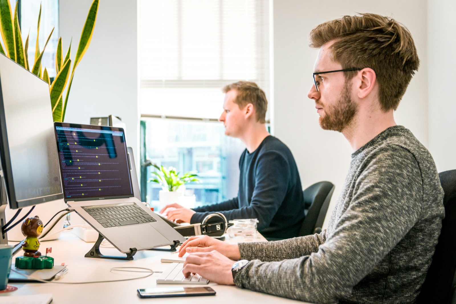 Two engineers collaborating at their desks